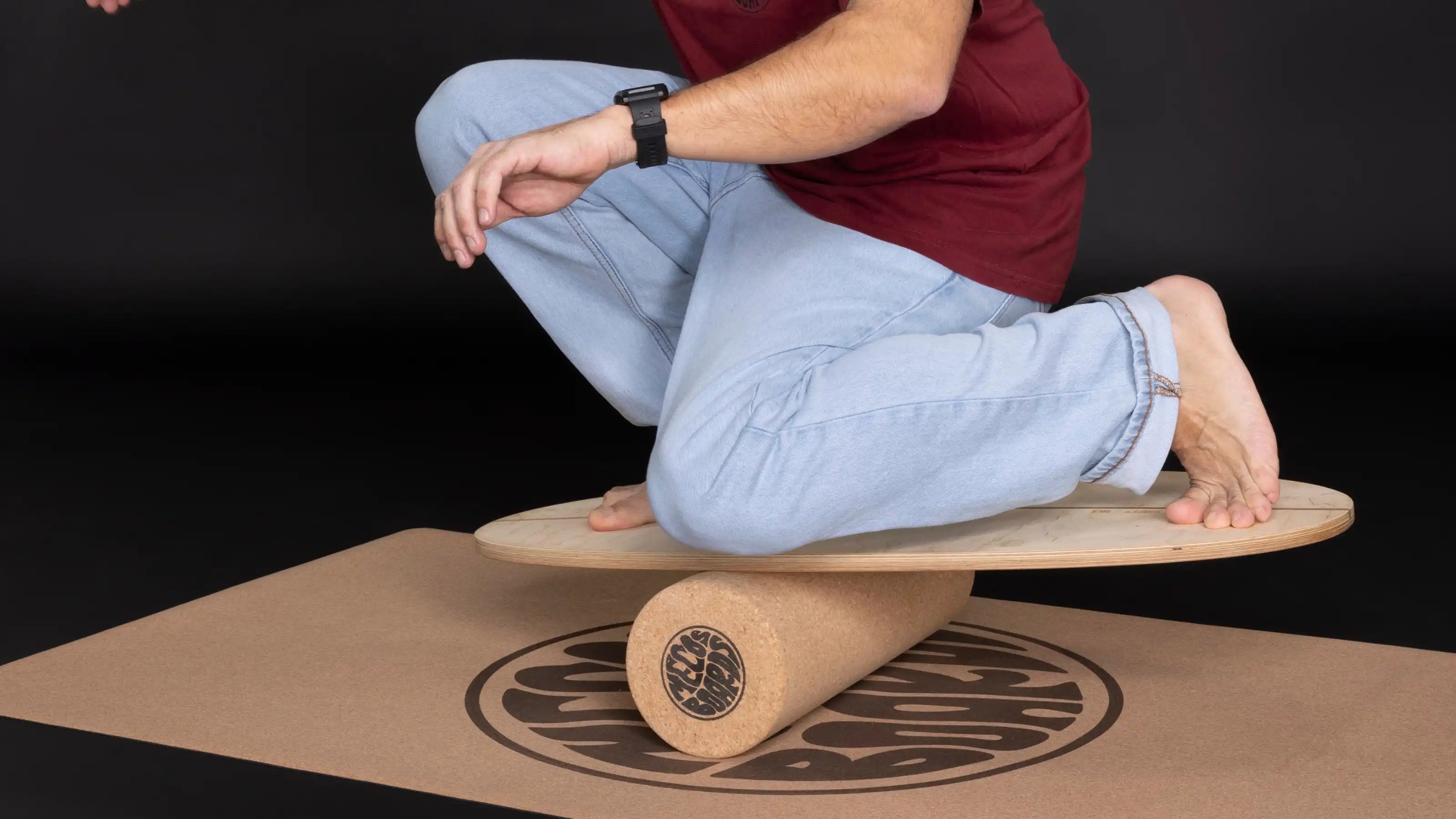 Person trainiert auf einem Balance Board aus Holz für Gleichgewicht und Koordination zuhause